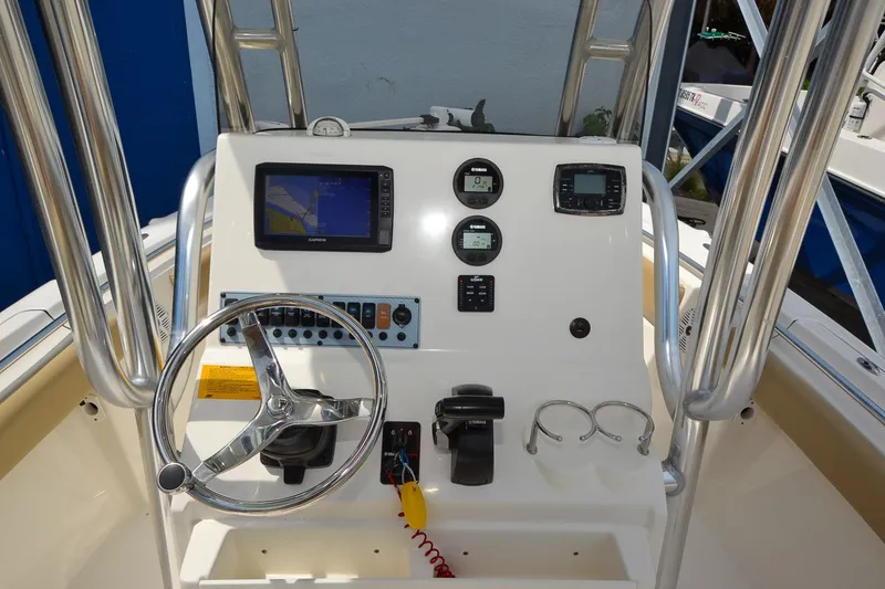 Slide: The Image of The image shows the helm of a Key West 219 FS boat with various instruments and a screen. - 10