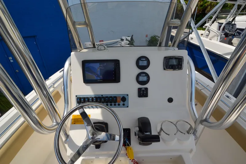 Slide: The Image of The image shows the helm of a 2018 Key West 219 FS boat. - 21
