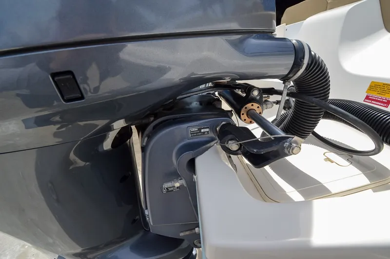 Slide: The Image of Close-up of an outboard motor on a boat, featuring cables and hoses. - 4