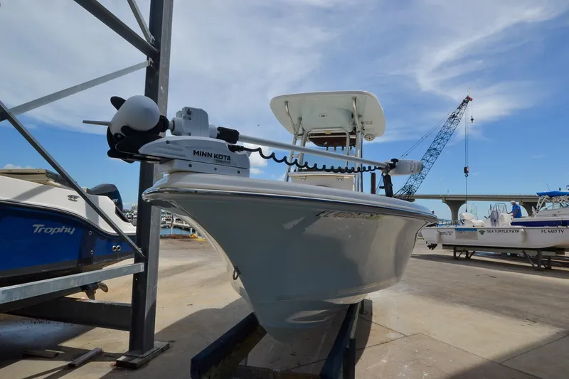 Slide: The Image of A 2018 Key West 219 FS boat is on a trailer in a harbor area. - 18