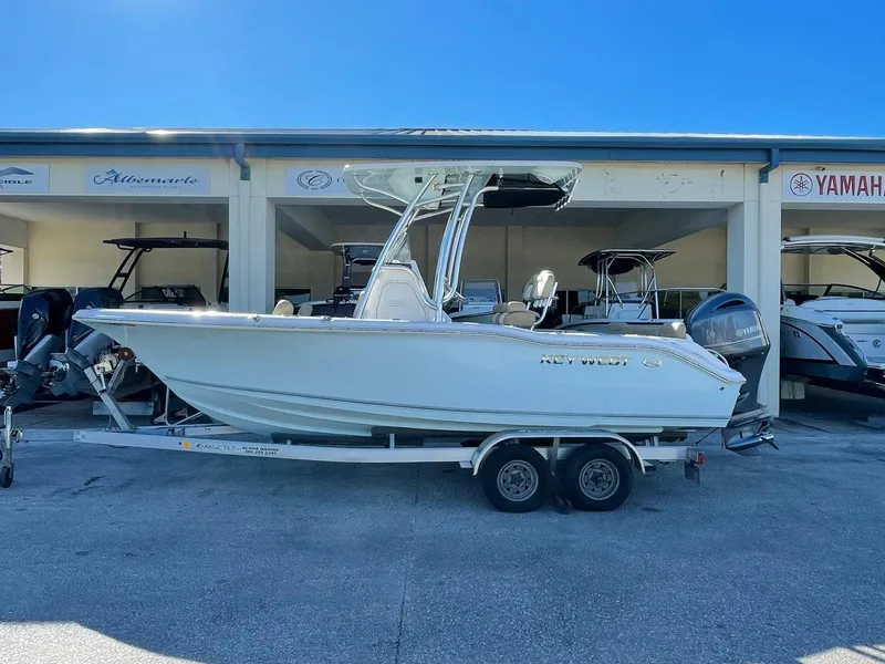 Slide: The Image of A 2018 Key West 219 FS boat on a trailer in a showroom setting. - 33