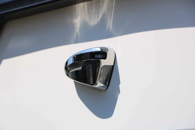Slide: The Image of Close-up of a shiny metal handle on a white boat. - 25