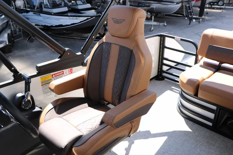 Slide: The Image of A luxurious captain's chair with brown and black upholstery in a modern boat. - 38