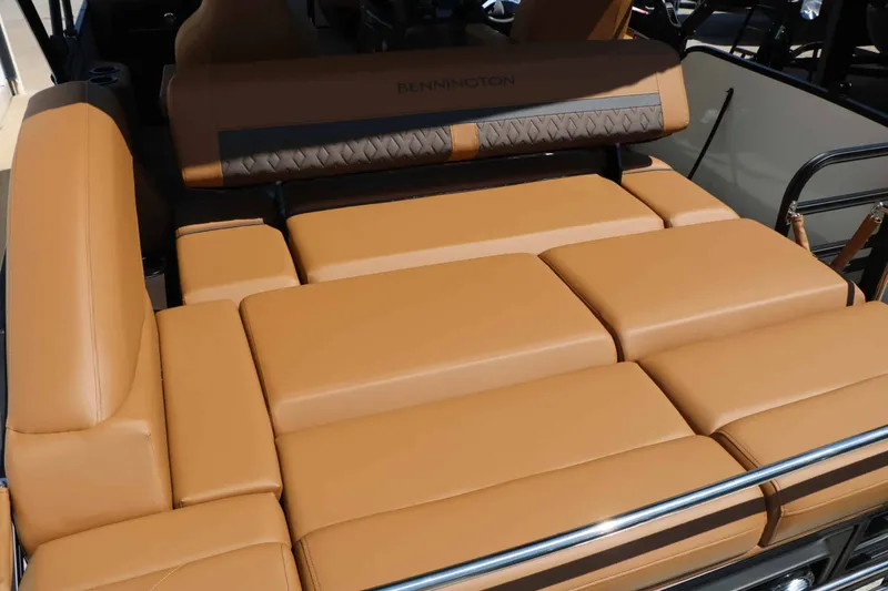 Slide: The Image of The image shows the luxurious brown upholstery of a Bennington 23 MSB boat. - 50