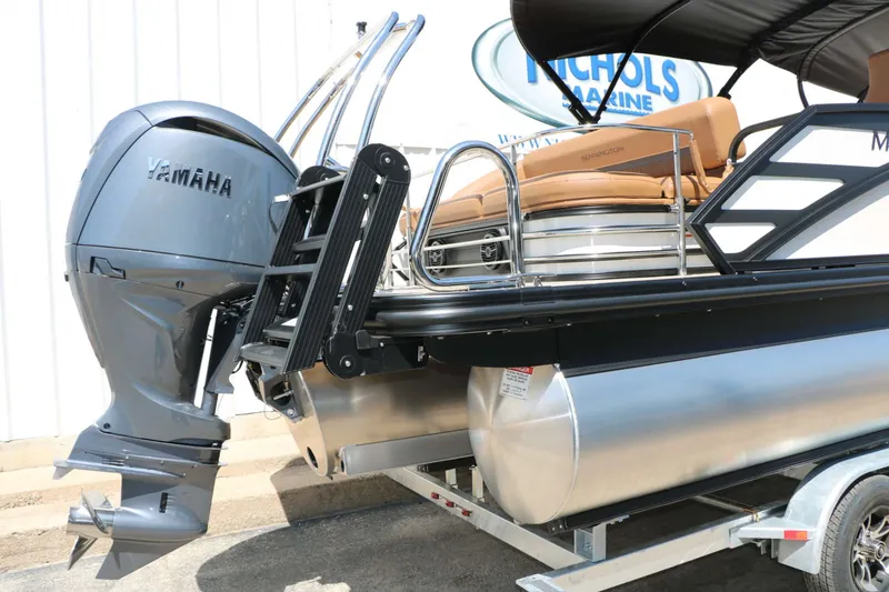 Slide: The Image of A Bennington 23 MSB pontoon boat with a Yamaha outboard motor, parked on a trailer. - 19