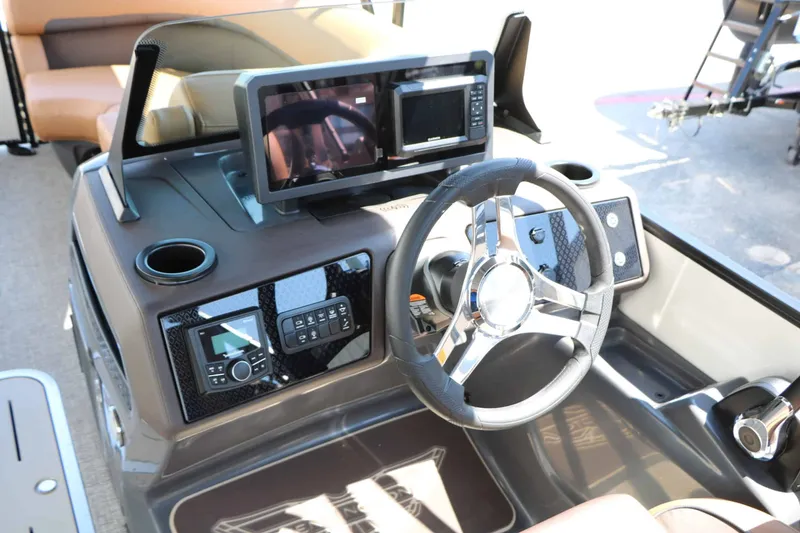 Slide: The Image of The image shows the helm of a 2027 Bennington 23 MSB with modern instruments and a sleek steering wheel. - 39