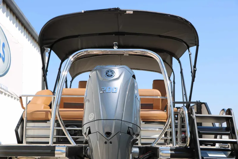 Slide: The Image of The image shows a Bennington 23 MSB boat with a large outboard motor and a sunshade. - 15
