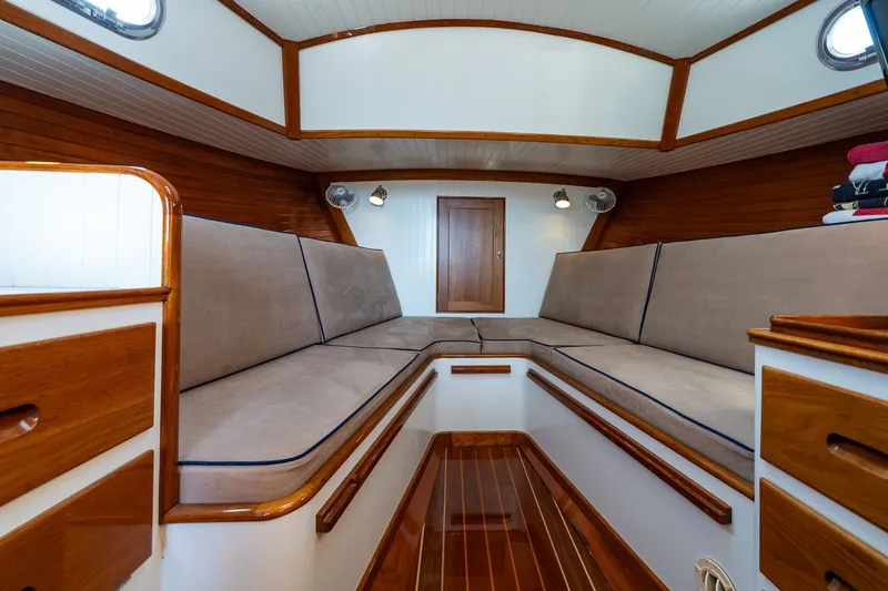 Slide: The Image of Interior of 2000 CH Marine 38 Runabout with wooden accents and beige seating. - 30