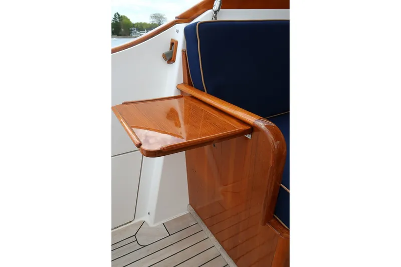 Slide: The Image of Wooden fold-out table on CH Marine 38 Runabout, 2000 model, with blue seating. - 19