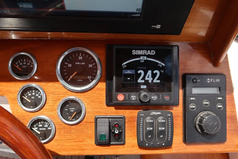 Slide: The Image of Dashboard of a 2000 CH Marine 38 Runabout with navigation and control instruments. - 11