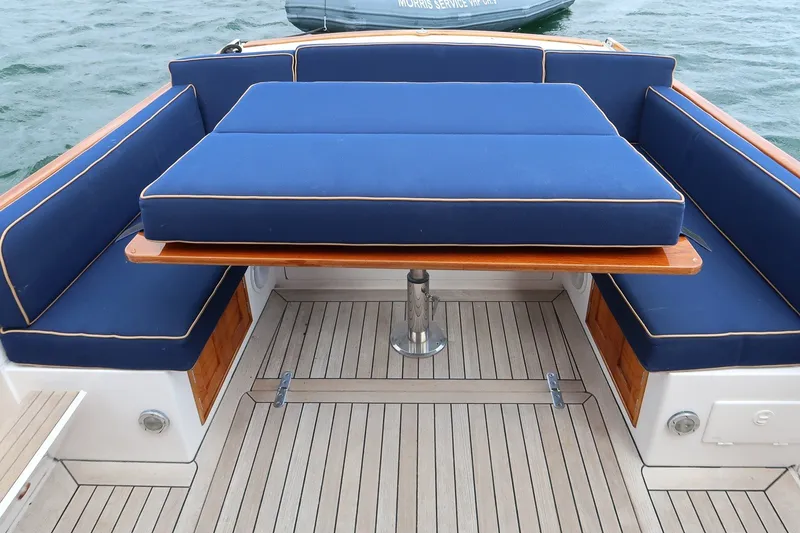 Slide: The Image of Luxury seating area on 2000 CH Marine 38 Runabout with blue cushions and wooden table. - 18