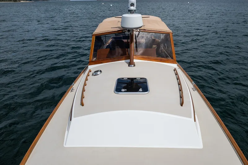 Slide: The Image of 2000 CH Marine 38 Runabout on calm water, showcasing sleek design and craftsmanship. - 22