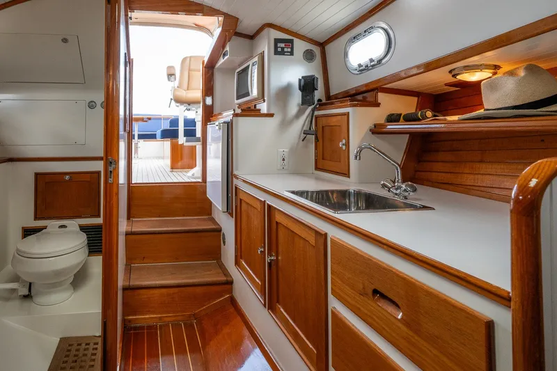 Slide: The Image of Interior of 2000 CH Marine 38 Runabout with kitchenette and wooden cabinetry. - 27
