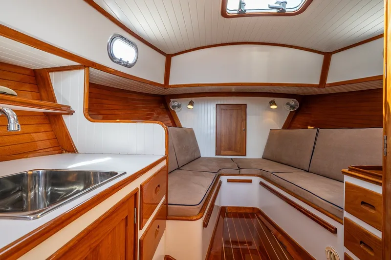 Slide: The Image of Interior of 2000 CH Marine 38 Runabout with wood accents and cozy seating area. - 29