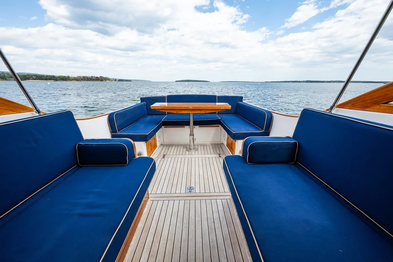 Slide: The Image of Luxurious CH Marine 38 Runabout boat interior with blue seating, wooden accents, and scenic water view. - 16