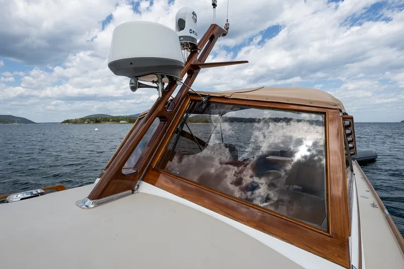 Slide: The Image of 2000 CH Marine 38 Runabout on water, featuring wooden trim and radar equipment. - 26