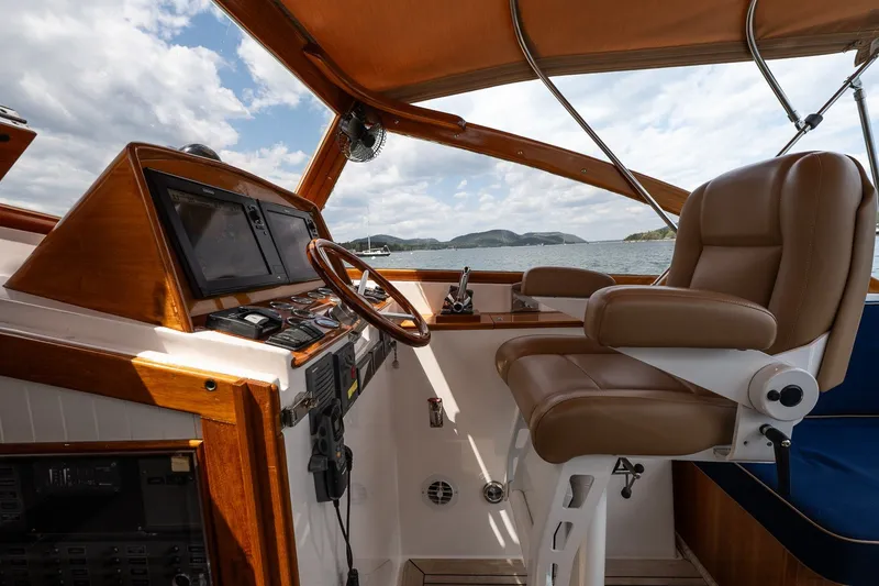 Slide: The Image of Luxurious helm of 2000 CH Marine 38 Runabout with leather seat and wooden dashboard. - 10