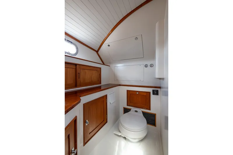 Slide: The Image of Luxurious CH Marine 38 Runabout 2000 boat bathroom with wooden cabinetry and modern fixtures. - 31