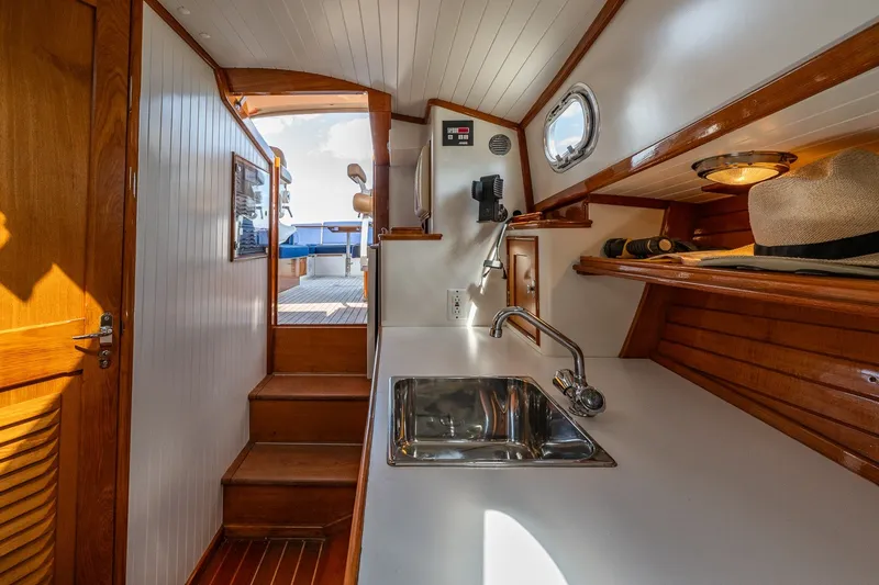 Slide: The Image of Interior of 2000 CH Marine 38 Runabout with wooden accents and compact sink area. - 25
