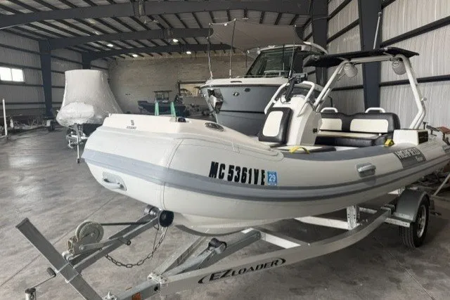 Slide: The Image of 2025 Highfield Velox 420 boat on trailer in indoor storage facility. - 1