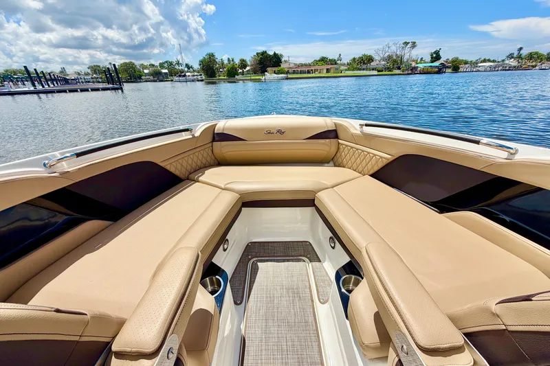 Slide: The Image of Luxurious interior of 2023 Sea Ray SLX 260 Outboard boat with tan seating and scenic water view. - 23