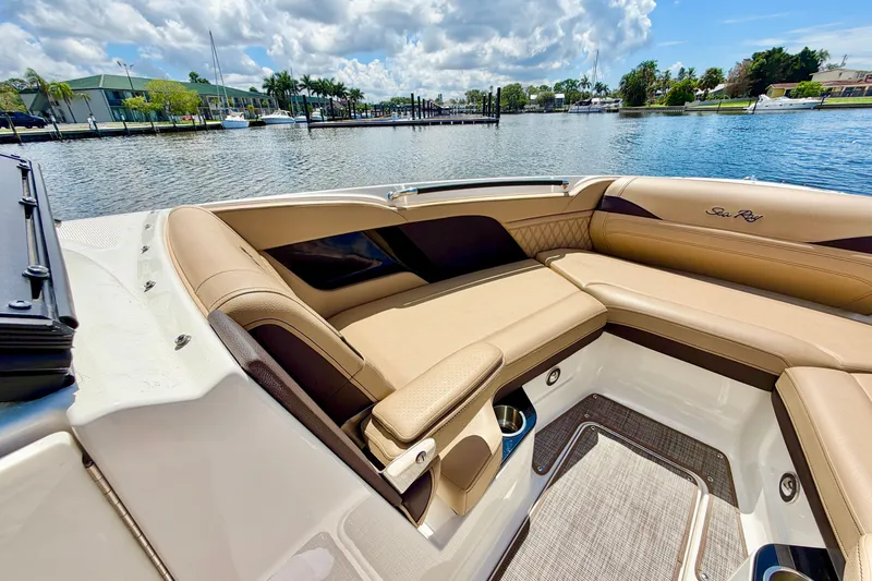 Slide: The Image of 2023 Sea Ray SLX 260 Outboard boat interior with luxurious seating on a sunny day. - 22