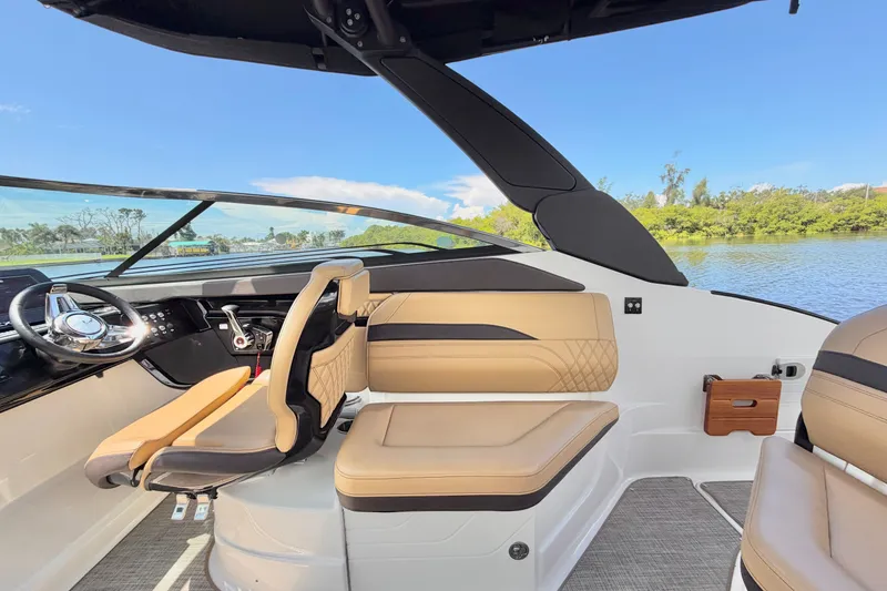 Slide: The Image of 2023 Sea Ray SLX 260 Outboard interior with luxurious seating and modern dashboard. - 21