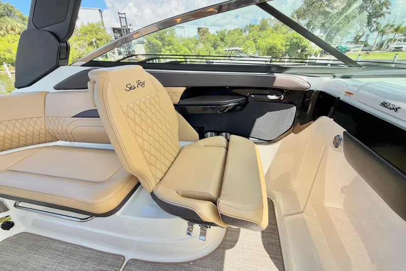 Slide: The Image of 2023 Sea Ray SLX 260 Outboard interior with luxurious tan seating and sleek design. - 15