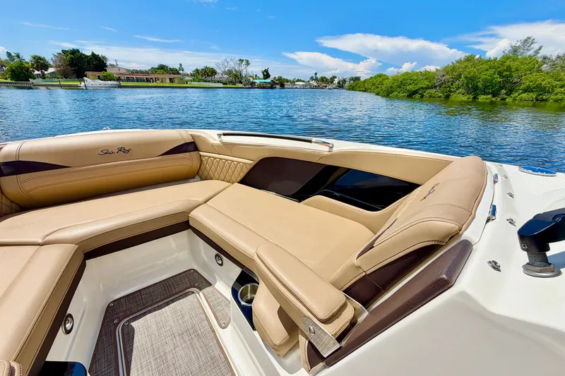 Slide: The Image of 2023 Sea Ray SLX 260 Outboard boat interior with luxurious seating on a sunny day. - 24