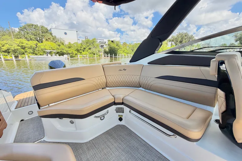 Slide: The Image of Luxurious seating on 2023 Sea Ray SLX 260 Outboard boat, featuring elegant tan upholstery. - 12