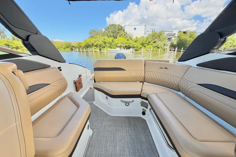 Slide: The Image of Luxurious interior of 2023 Sea Ray SLX 260 Outboard boat with tan seating and scenic water view. - 11