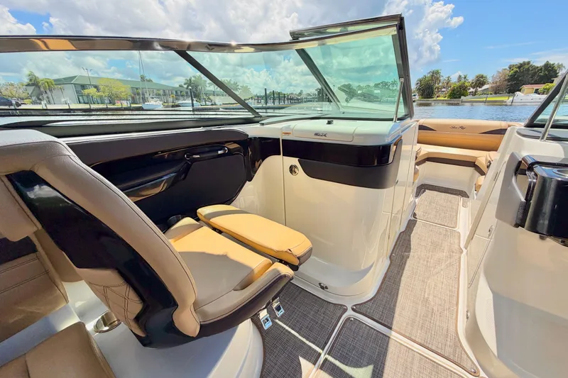 Slide: The Image of Luxurious 2023 Sea Ray SLX 260 Outboard boat interior with plush seating and sleek design. - 16