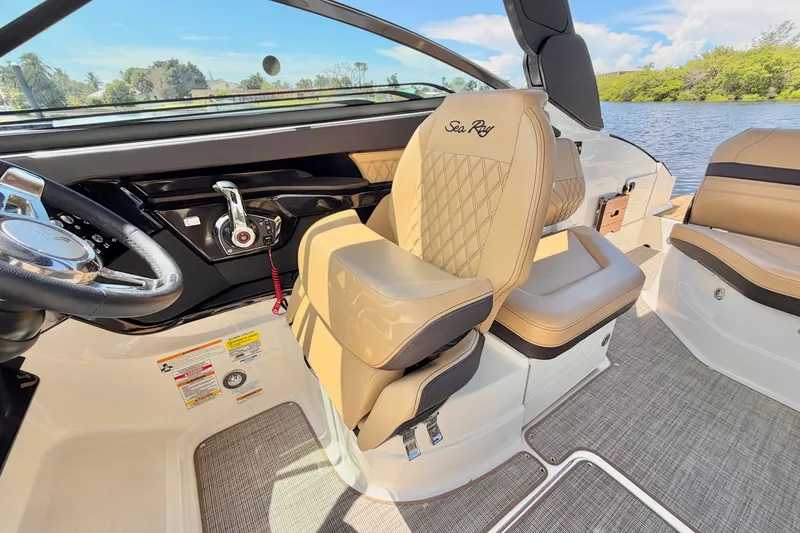 Slide: The Image of 2023 Sea Ray SLX 260 Outboard interior with luxurious seating and modern controls. - 18