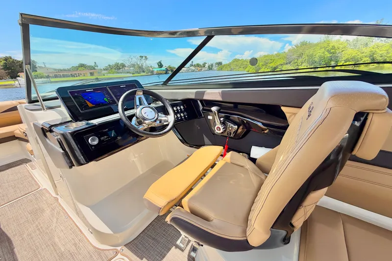 Slide: The Image of 2023 Sea Ray SLX 260 Outboard helm with modern controls and navigation display. - 19