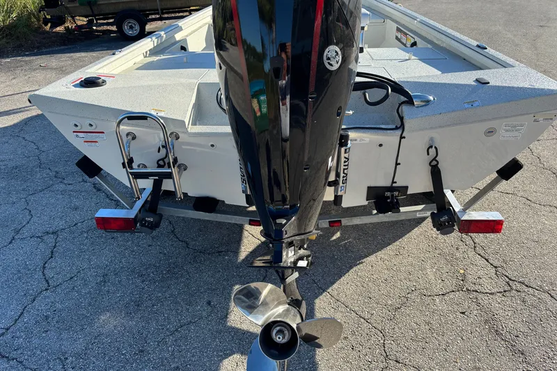Slide: The Image of 2027 Ranger RB190 boat with outboard motor and trailer, parked on pavement. - 1