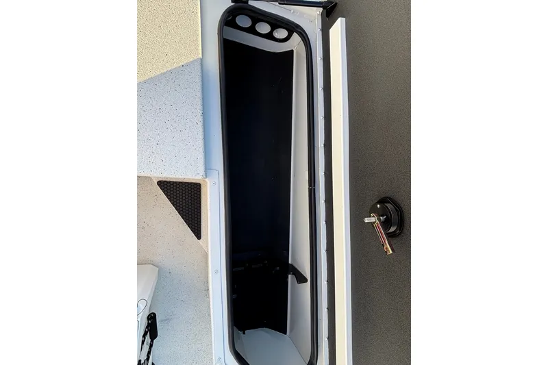 Slide: The Image of Open storage compartment of 2027 Ranger RB190 boat, showcasing interior design and latch mechanism. - 9