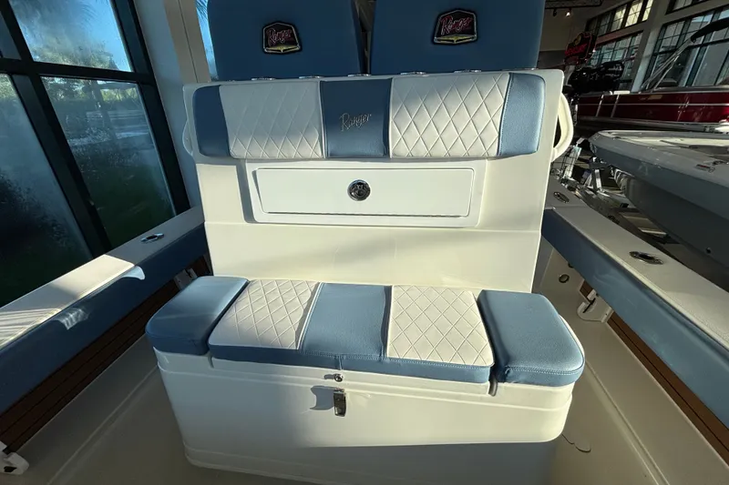 Slide: The Image of 2025 Ranger 2600 Bay boat interior with blue and white cushioned seating. - 5