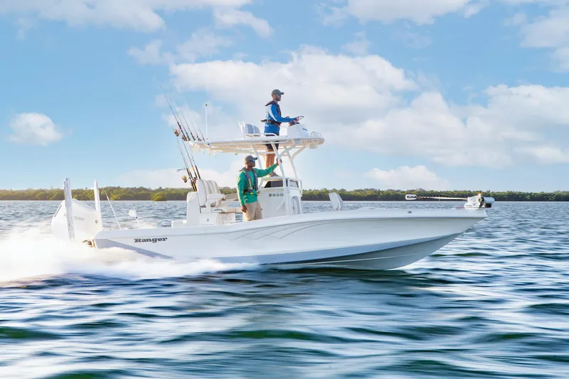Slide: The Image of Manufacturer Provided Image: 2025 Ranger 2600 Bay boat cruising on open water under a clear blue sky. - 15
