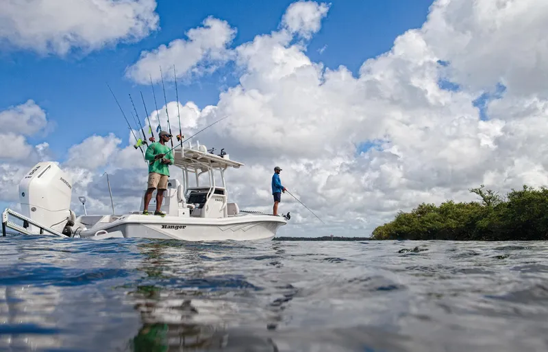 Slide: The Image of Manufacturer Provided Image: 2025 Ranger 2600 Bay boat with anglers fishing under a cloudy sky. - 12