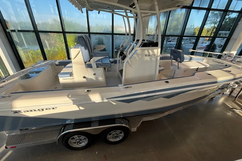 Slide: The Image of 2025 Ranger 2600 Bay boat displayed indoors with sleek design and modern features. - 2