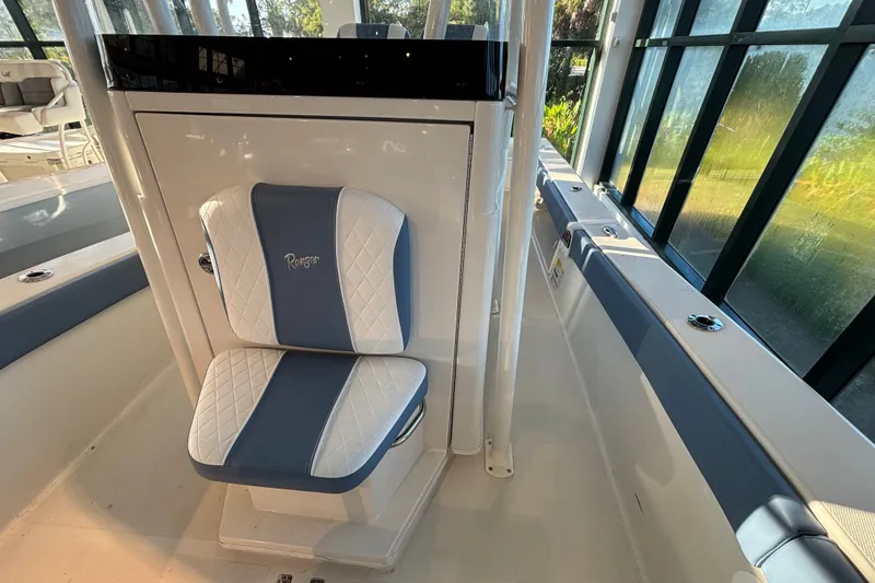Slide: The Image of 2025 Ranger 2600 Bay boat interior with blue and white cushioned seating. - 9
