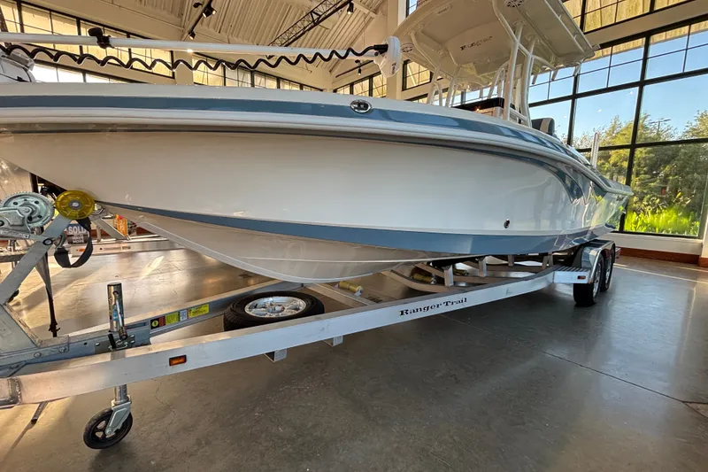 Slide: The Image of 2025 Ranger 2600 Bay boat on trailer in showroom, side view. - 0