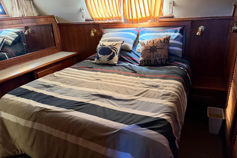 Slide: The Image of Cozy bedroom in 1984 Californian 43 Cockpit MY yacht with nautical-themed decor. - 41