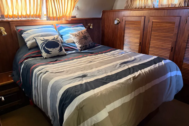 Slide: The Image of Cozy bedroom interior of 1984 Californian 43 Cockpit MY yacht with nautical-themed decor. - 43
