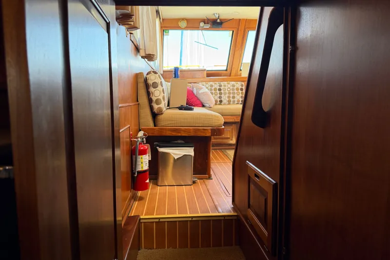 Slide: The Image of Interior of 1984 Californian 43 Cockpit MY yacht, featuring cozy seating and wooden finishes. - 51