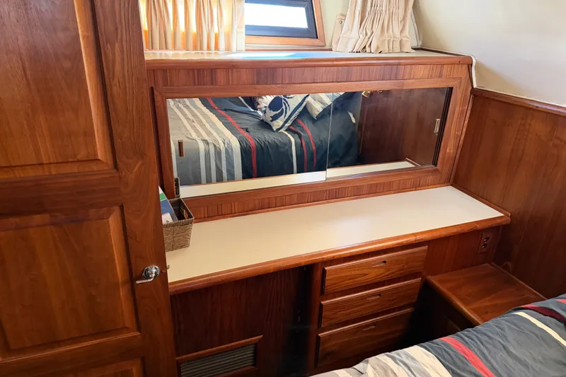 Slide: The Image of 1984 Californian 43 Cockpit MY cabin with wooden vanity, mirror, and drawers. - 42