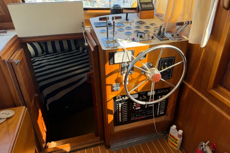 Slide: The Image of 1984 Californian 43 Cockpit MY helm with steering wheel, gauges, and striped cabin interior. - 24