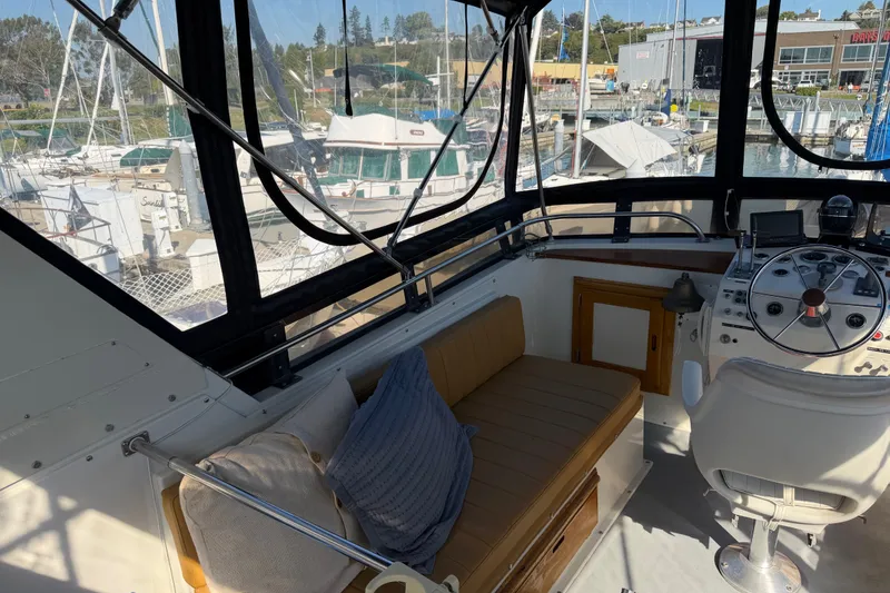 Slide: The Image of 1984 Californian 43 Cockpit MY yacht interior with helm, seating, and marina view. - 15