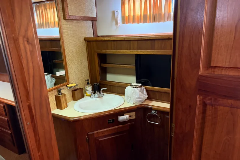 Slide: The Image of 1984 Californian 43 Cockpit MY bathroom with wooden cabinetry and sink. - 47