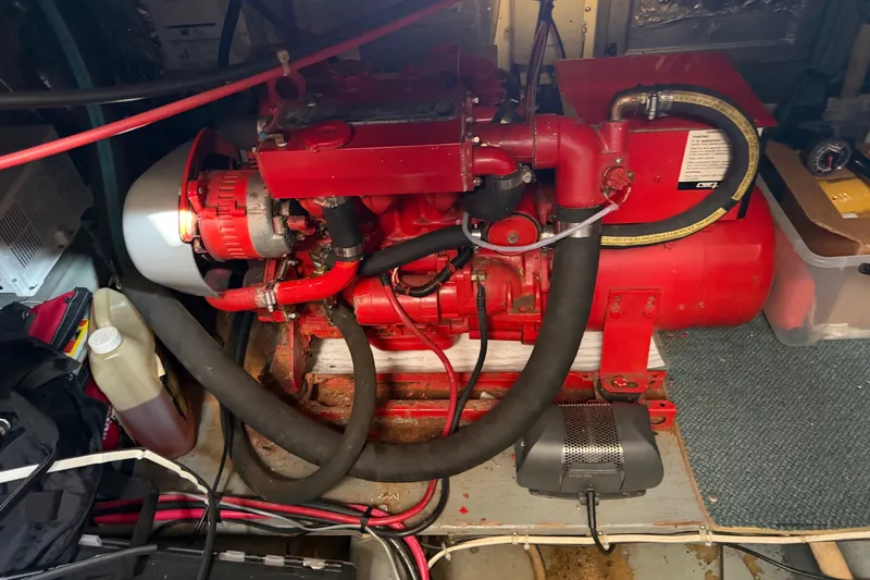 Slide: The Image of Engine room of 1984 Californian 43 Cockpit MY with red marine engine. - 57